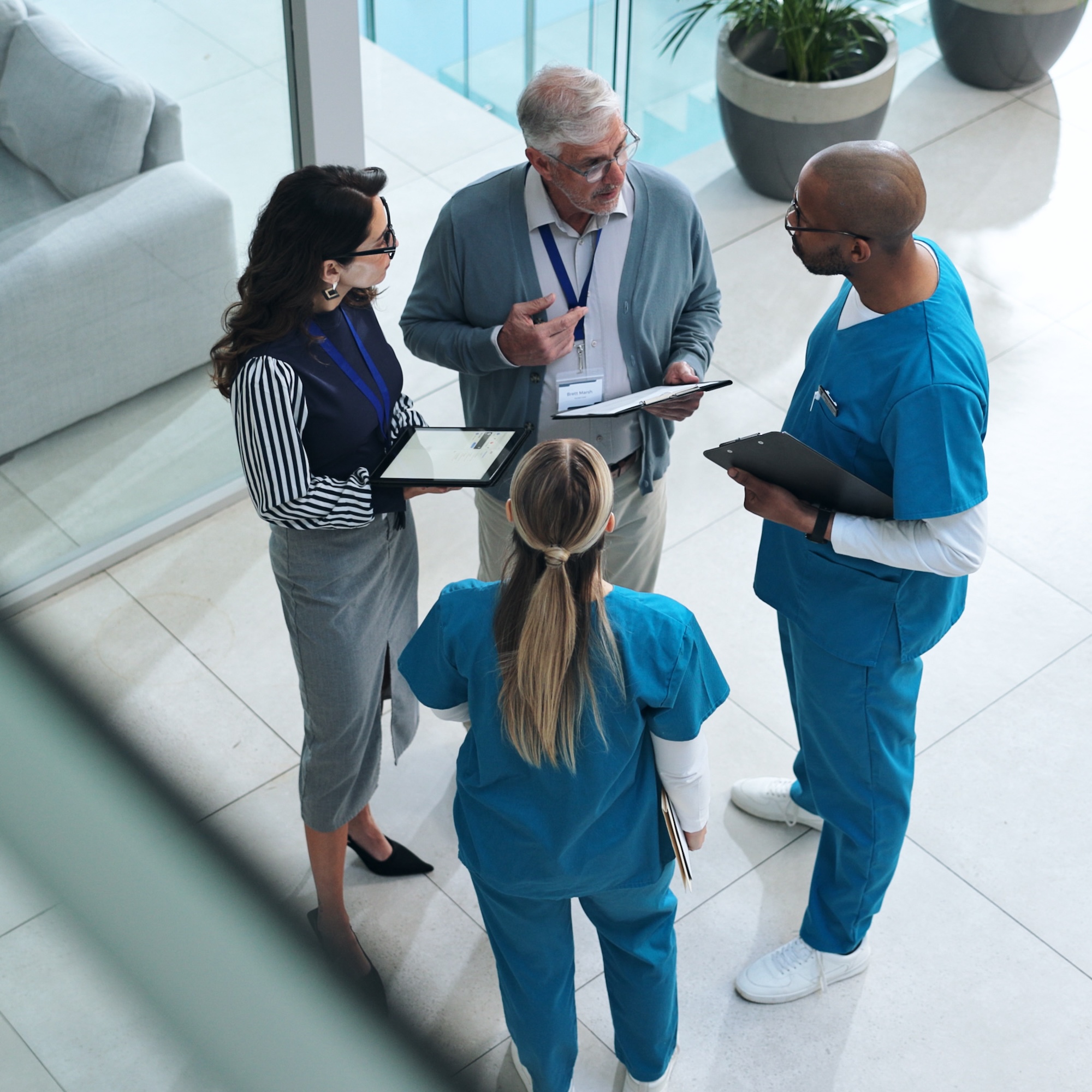 Doctors, medical team and tablet with discussion, advice and above for surgery or patient records. People, tech and nurse for professional opinion, help and results in healthcare, clinic or hospital